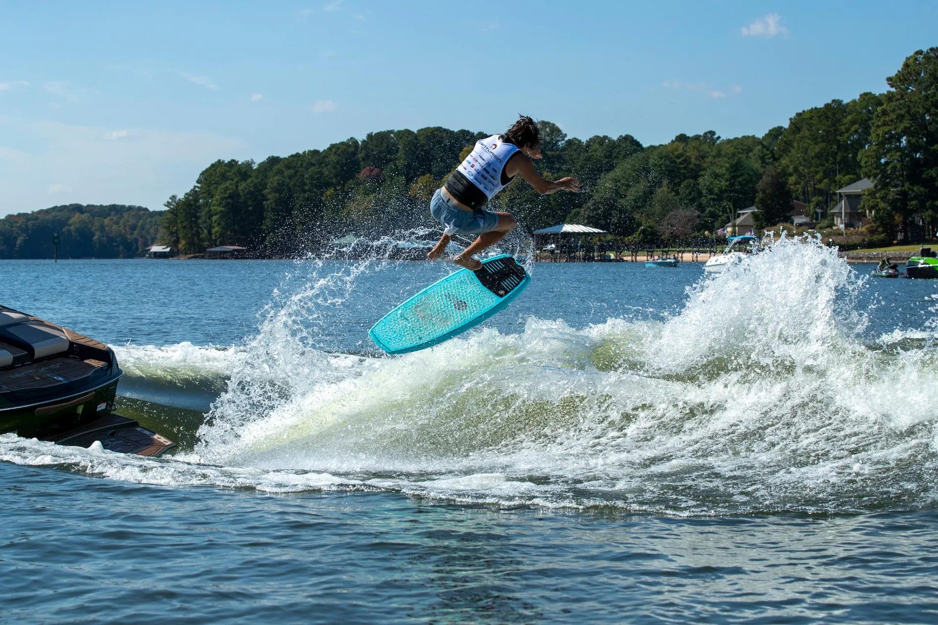 A man is riding a wakesurf board in the water.