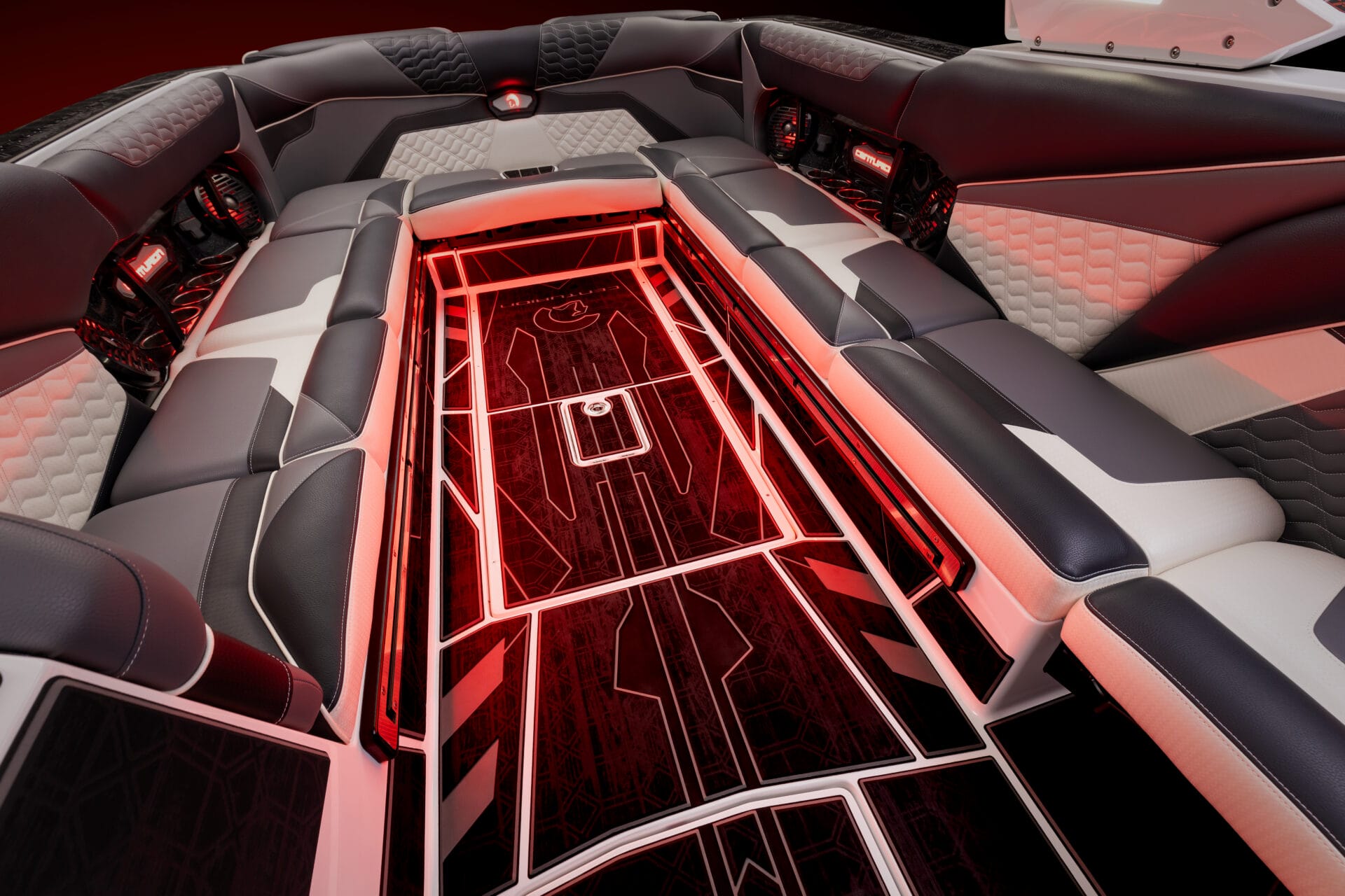 Interior view of a luxury boat featuring leather seats and red LED floor lighting, arranged in a spacious seating layout with a modern design. Customize My Ride for a personalized touch that elevates opulence on the open water.