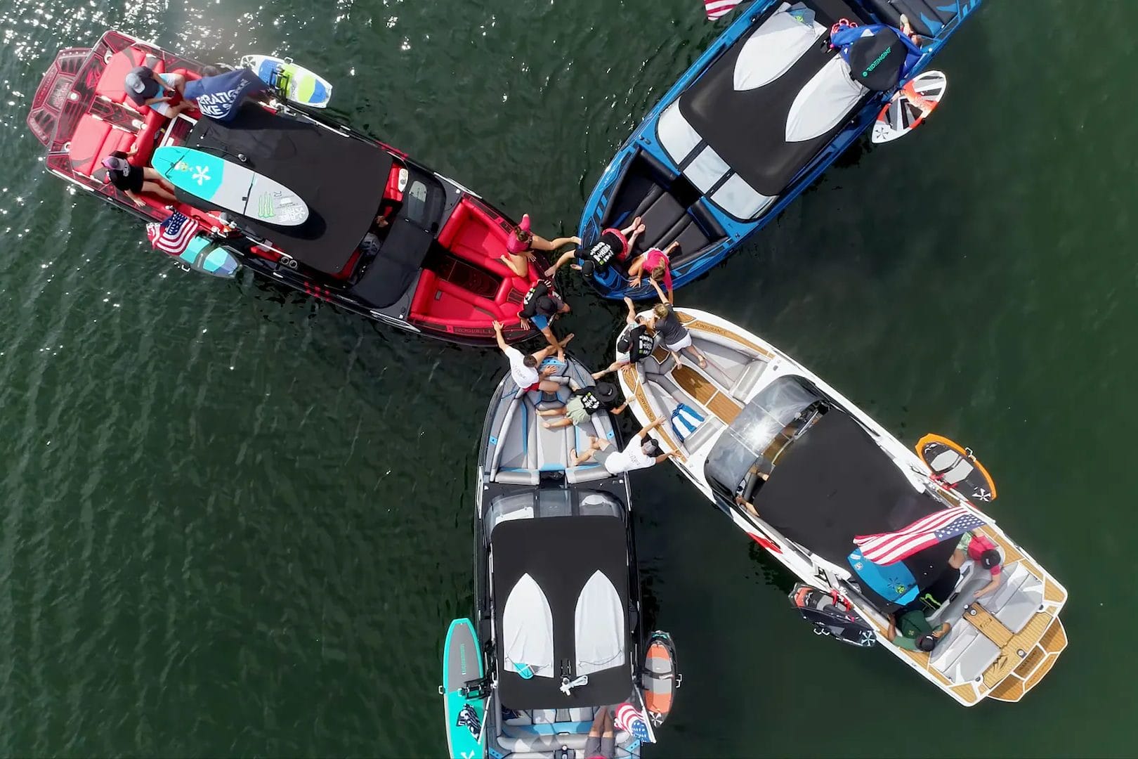 A group of people on wakeboats in the water.