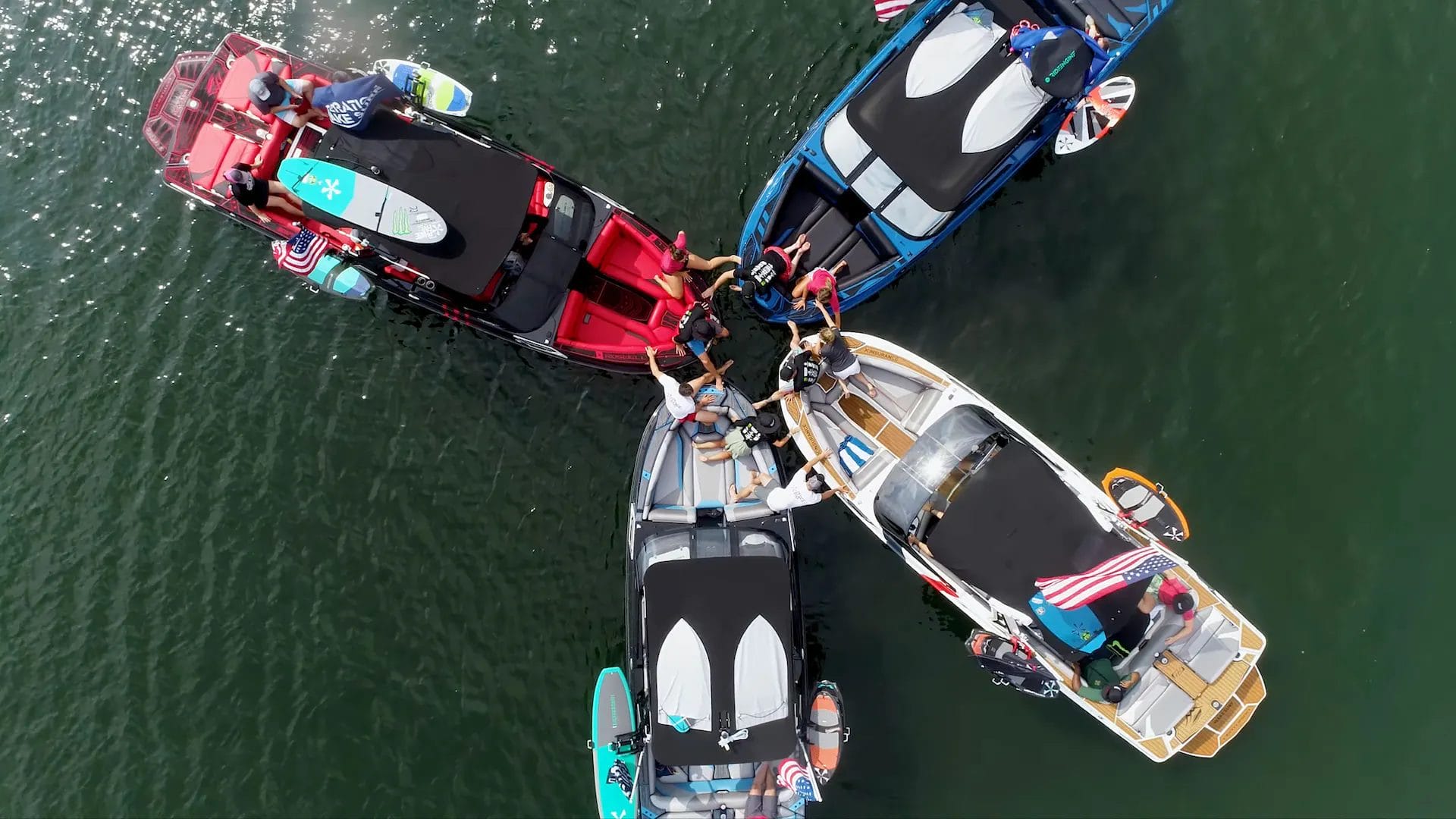 A group of people on wakeboats in the water.