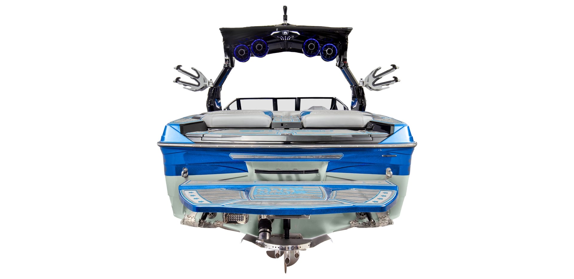 Rear view of a blue Centurion Ri230 wakeboard boat with a tower and speakers, showcasing seating and the wakeboard holders.