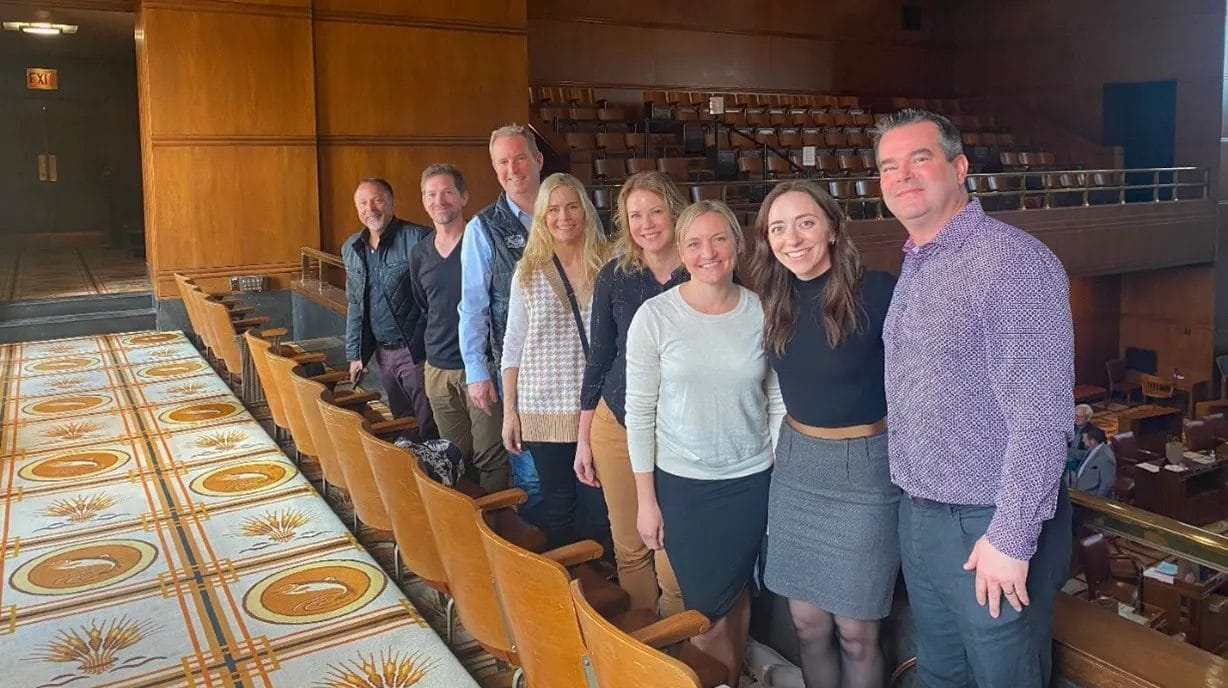 A group of people posing for a photo in an auditorium.