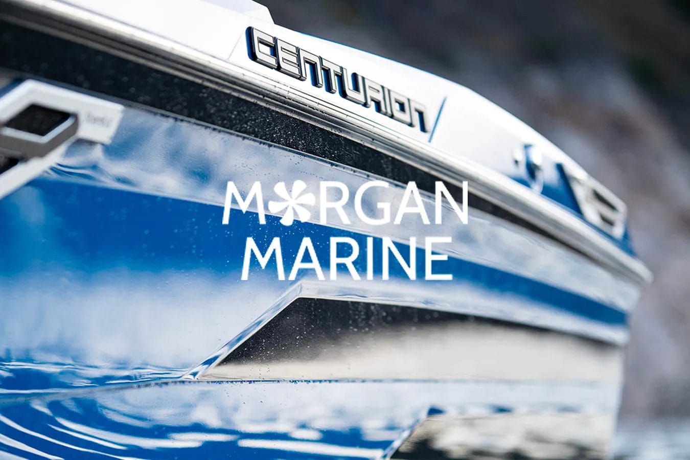 A blue wakesurf boat with the words margan marine on it.