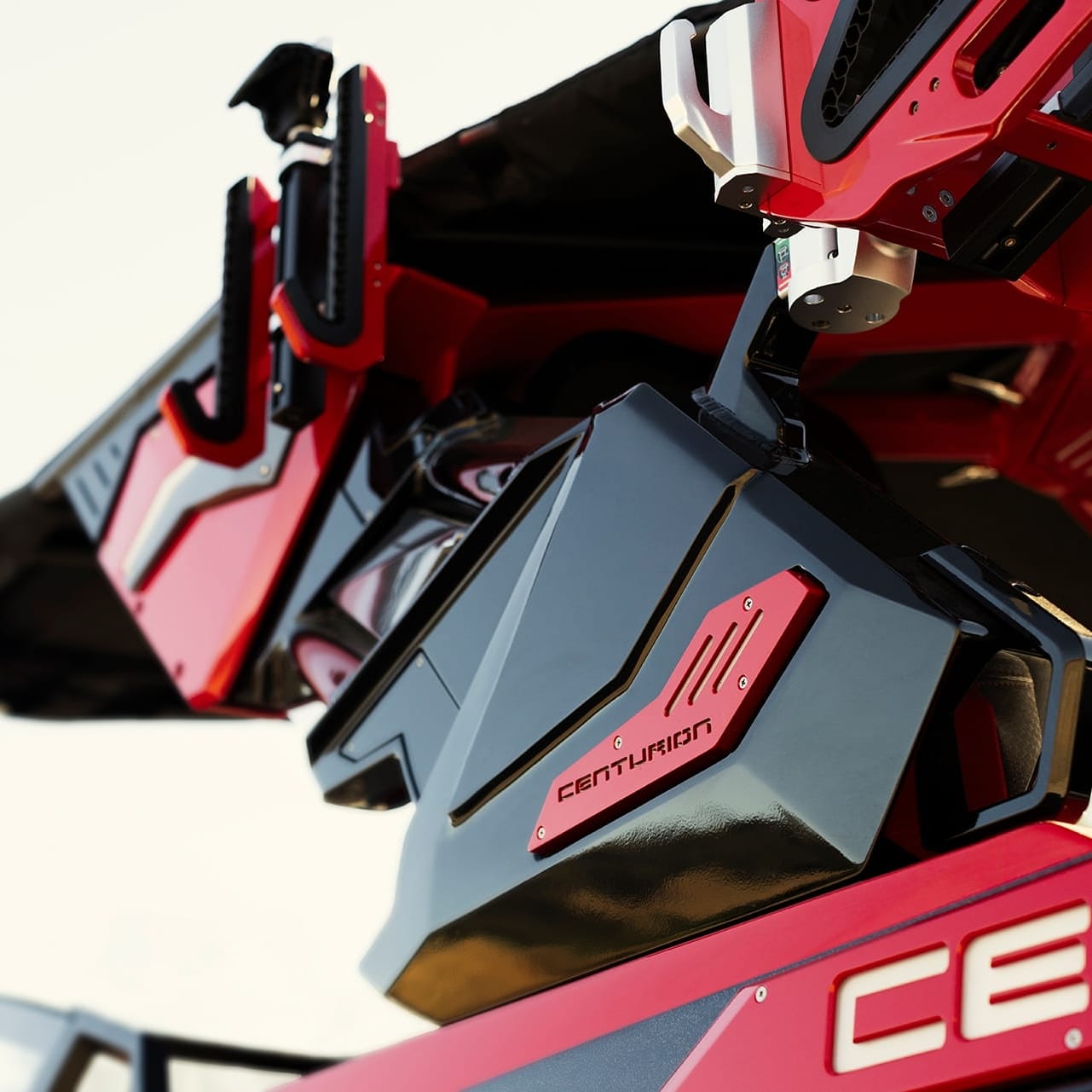 Close-up of the machinery parts of a Centurion Ri265 boat, highlighting its sleek design and branding. The predominant colors are red and black.