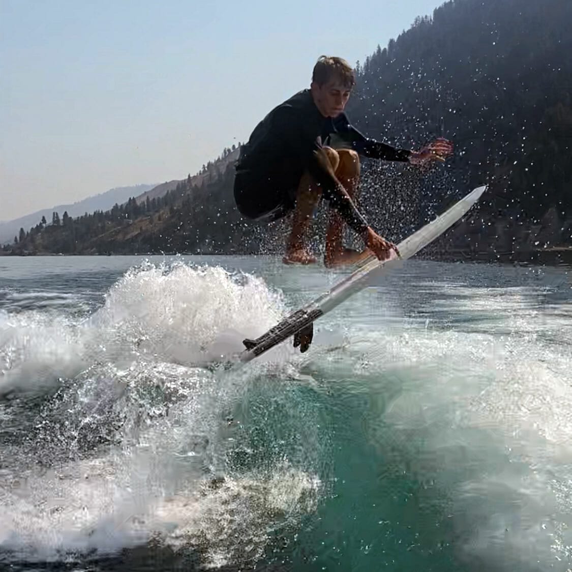 A man riding a wave on a surfboard.