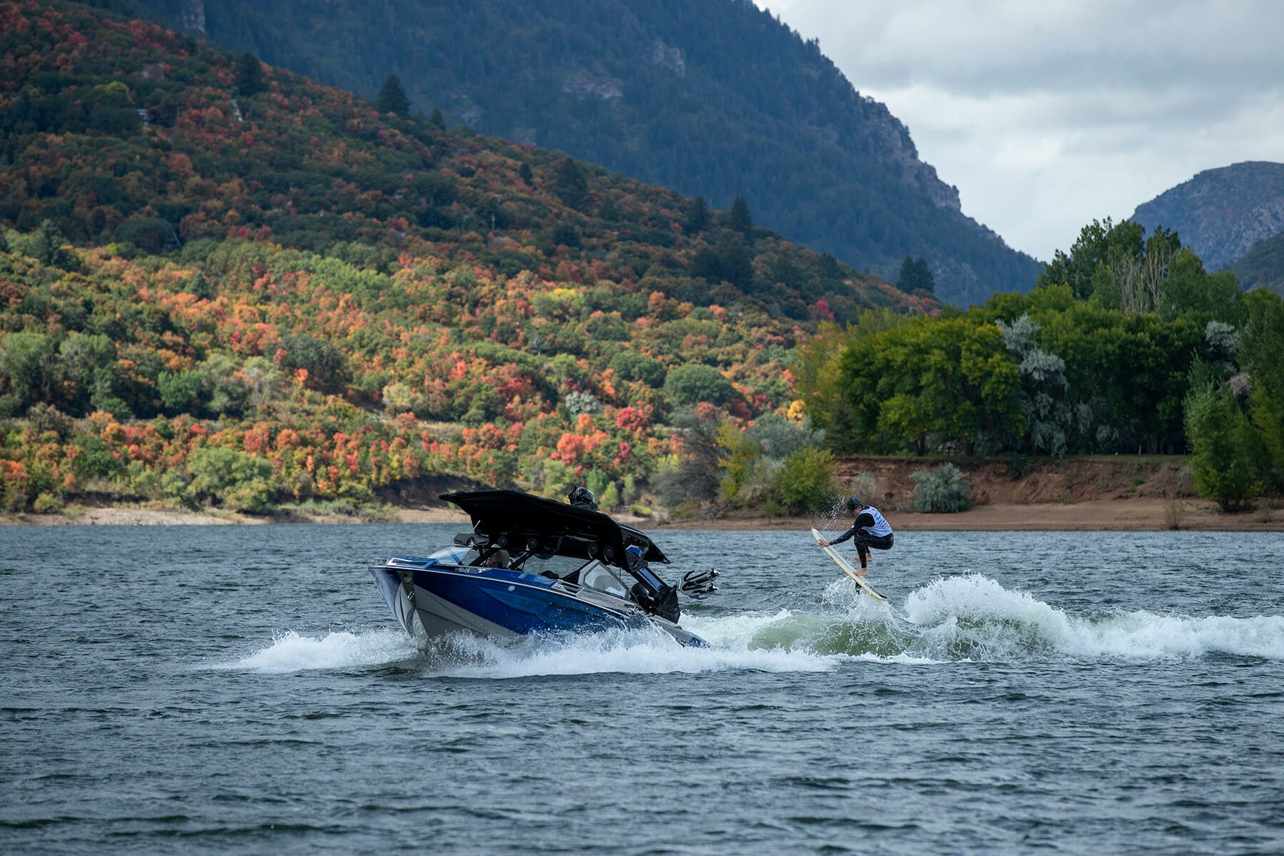 A person is riding a boat on a lake.