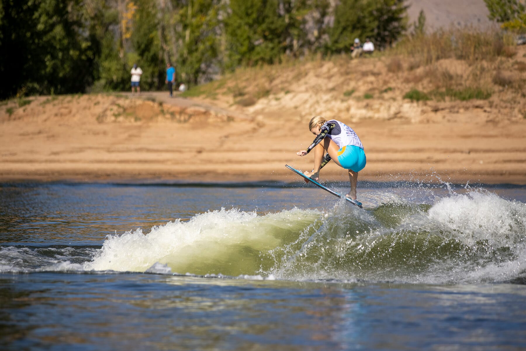 2024 WWSC Day 2 Recap: A man is riding a surfboard in the water.