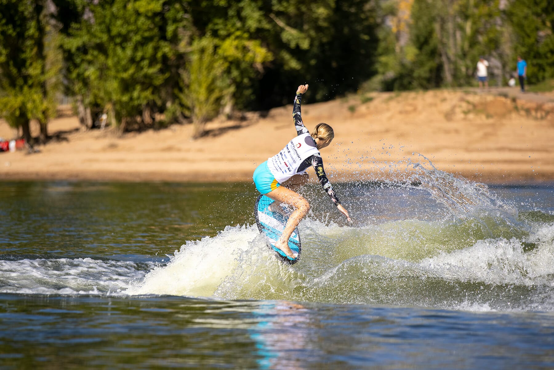 2024 WWSC Day 2 Recap: A woman surfs a wave on a surfboard.