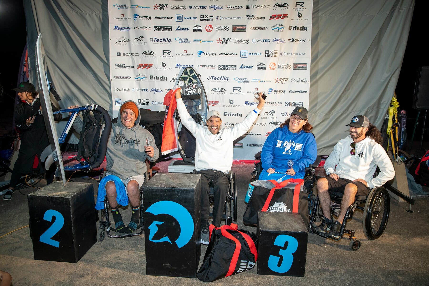 A group of people in wheelchairs on a podium, giving the 2024 WWSC Day 2 Recap.