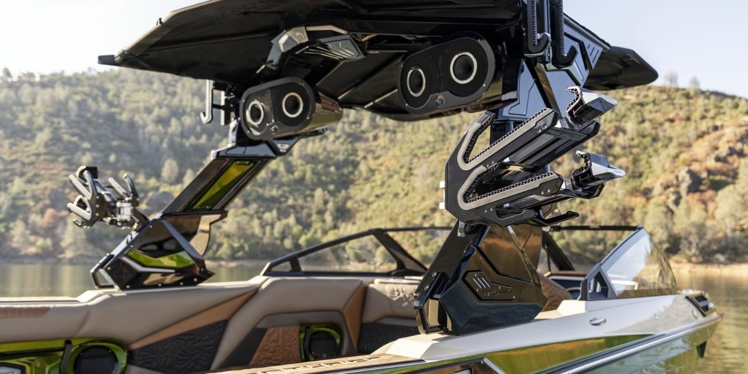 The front of a boat with a wakesurf board attached to it.