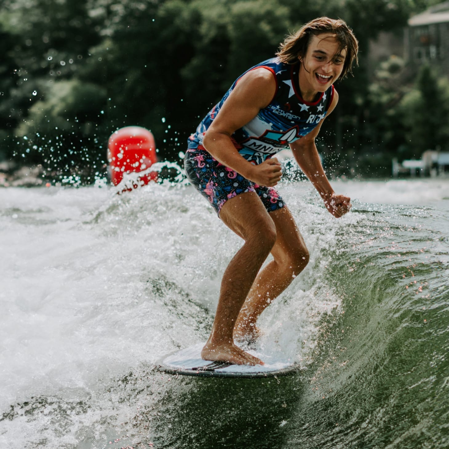 A man riding a wave on a surfboard.