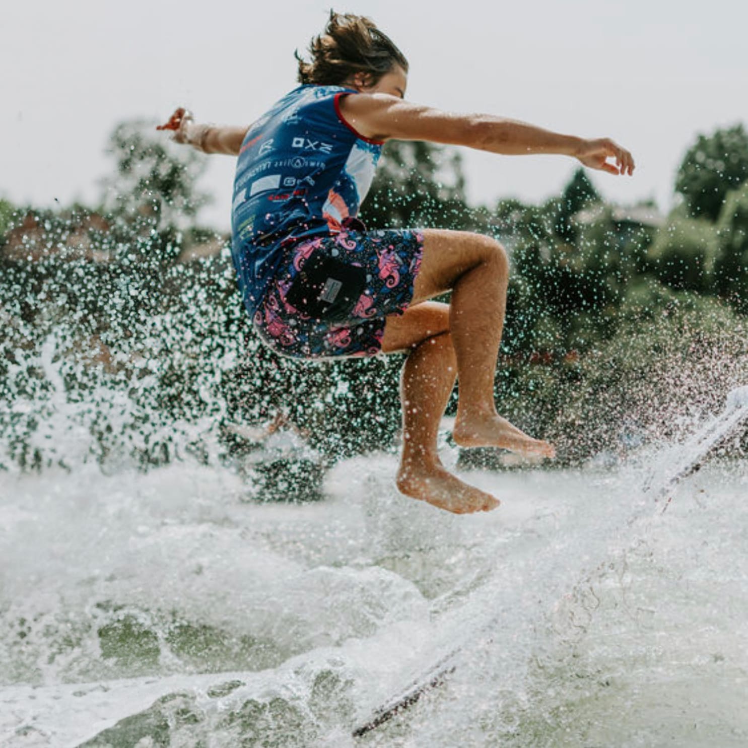 A man is riding a wave on a surfboard.