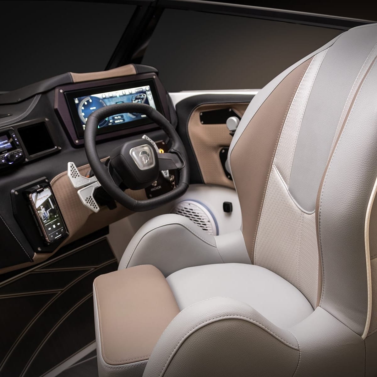 A modern boat cockpit with a grey and beige captain's chair, multiple control screens, and a steering wheel in beige and black colors.