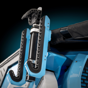 Close-up of a mechanical device with blue components and black textured grips mounted on a vehicle.