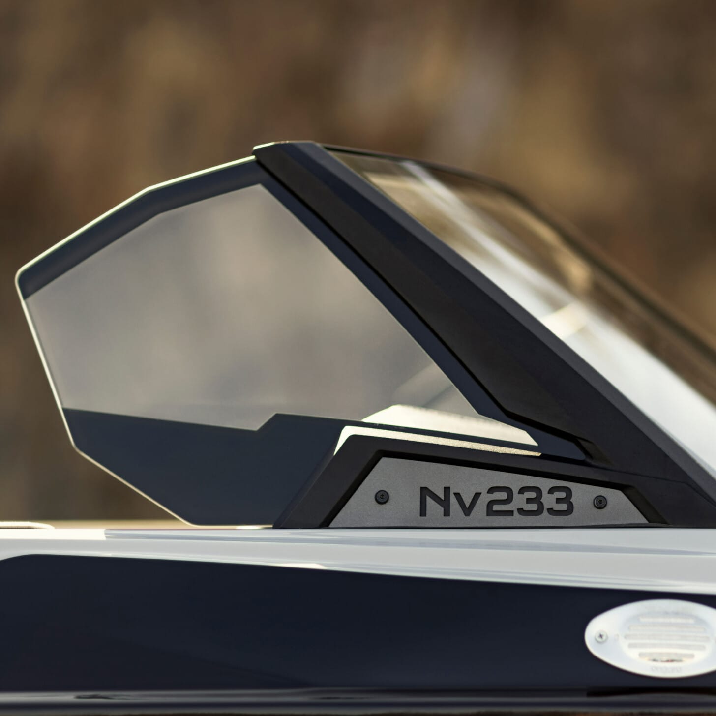 Close-up of a modern boat's sleek black and gray windshield with 