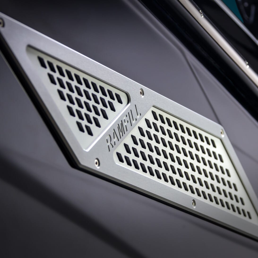 Close-up of a metal ventilation grille marked 