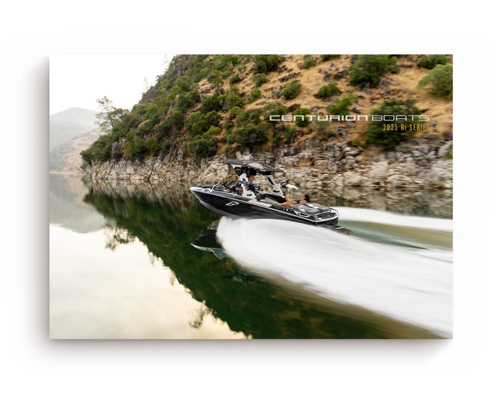 A black Centurion boat speeds along a calm river with rocky hills in the background. Text reads 